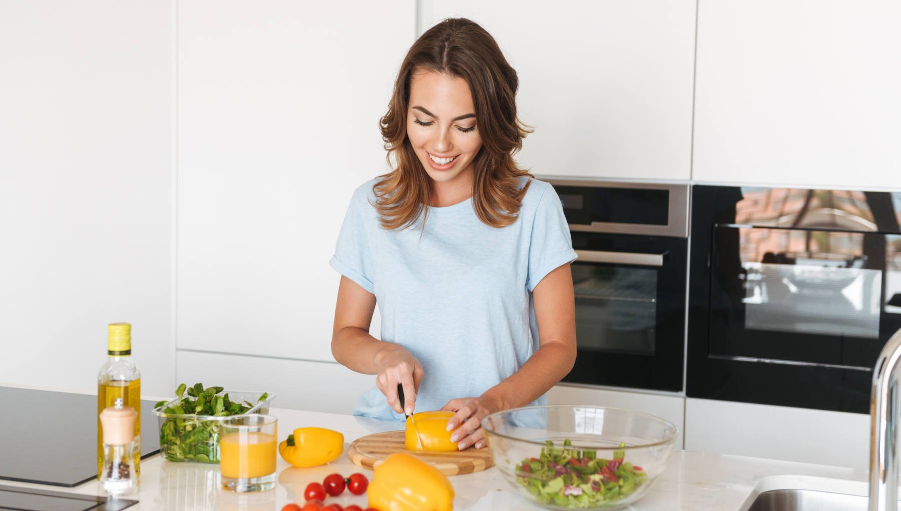 Woman in preparing a healthy meal in the kitchen